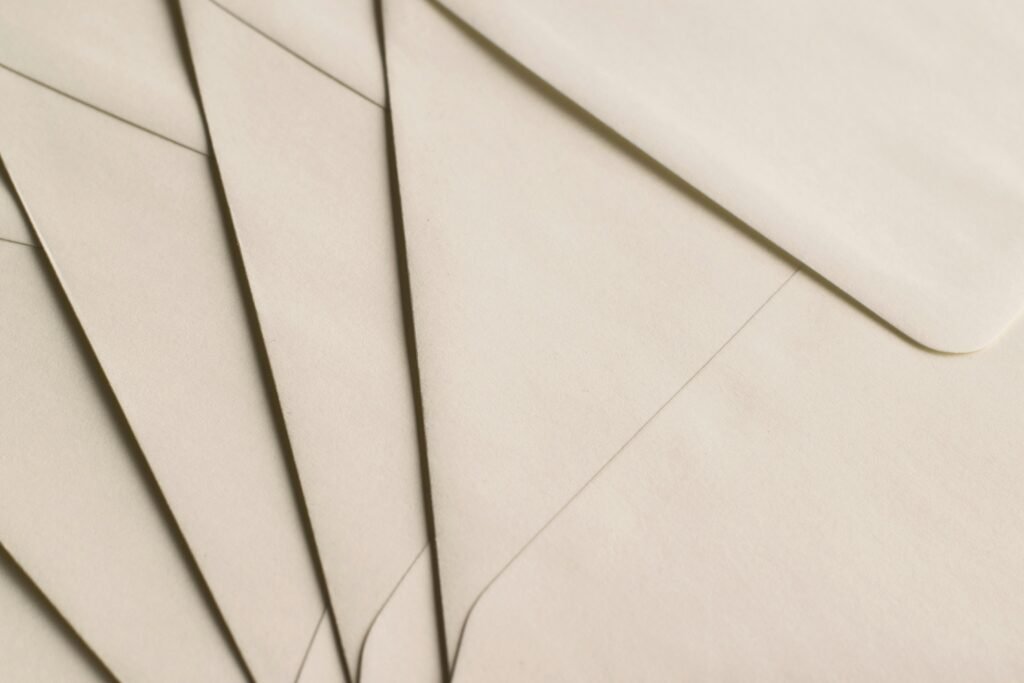 A close-up photo of beige envelopes arranged on a neutral background, ideal for stationery themes.